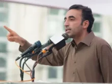 PPP Chairman Bilawal Bhutto Zardari speaking passionately at a political rally mic in Muzaffarabad
