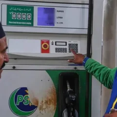 A fuel pump nozzle being used at a petrol pump station in Pakistan for vehicle refueling