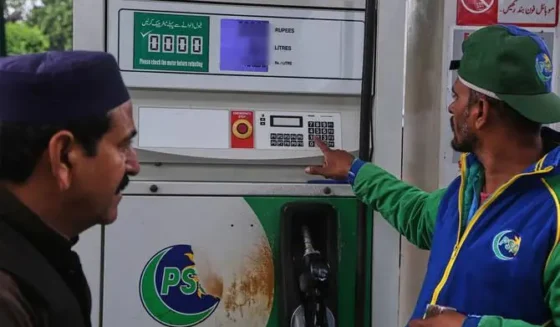 A fuel pump nozzle being used at a petrol pump station in Pakistan for vehicle refueling